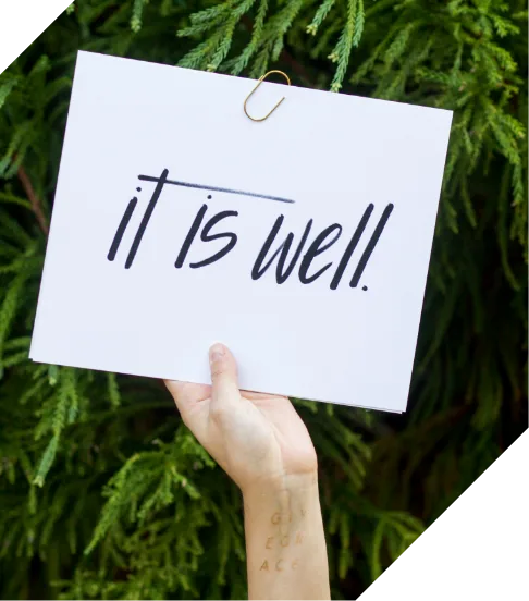 It is well note held in front of greenery